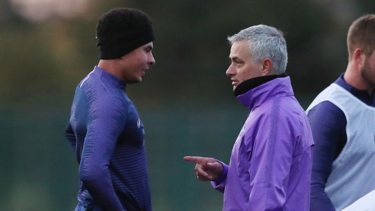 Jose Mourinho speaks to Dele Alli during a Tottenham training session