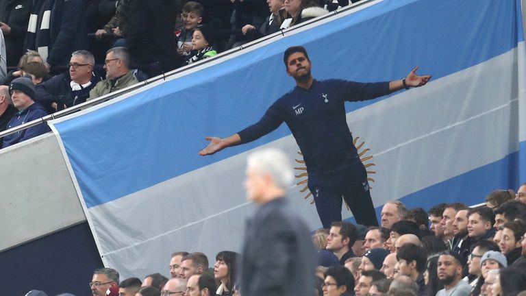 A flag for former Tottenham Hotspur manager Mauricio Pochettino is displayed in the crowd as Jose Mourinho, Manager of Tottenham Hotspur looks on during the UEFA Champions League group B match between Tottenham Hotspur and Olympiacos FC at Tottenham Hotspur Stadium
