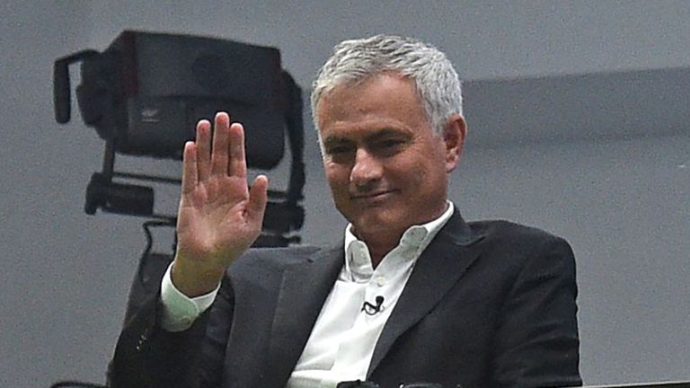 Former manager Jose Mourinho (C) waves to fans from the TV studio during the English Premier League football match between Manchester United and Liverpool at Old Trafford in Manchester, north west England, on October 20, 2019