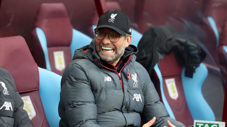 Jurgen Klopp smiles in the dugout during Liverpool's trip to Aston Villa.