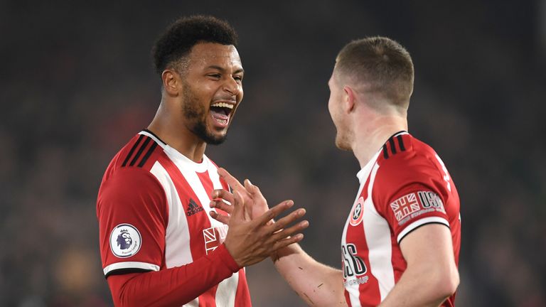 Lys Mousset celebrates scoring against Manchester United with John Lundstram