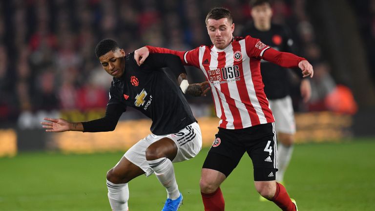 Manchester Unite forward Marcus Rashford battles for possession with Sheffield United midfielder John Fleck