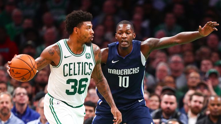 Marcus Smart of the Boston Celtics drives to the basket while guarded by Dorian Finney-Smith of the Dallas Mavericks