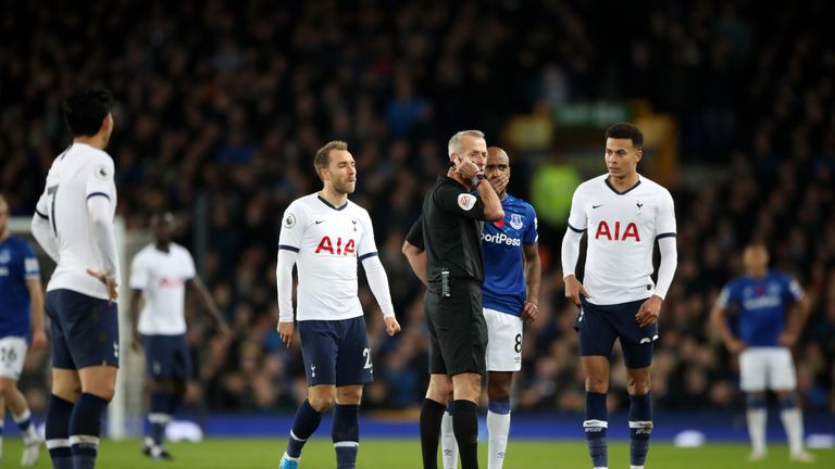 Martin Atkinson discusses a VAR decision with Stockley Park