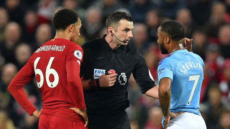 English referee Michael Oliver (C) chats with Manchester City&#39;s English midfielder Raheem Sterling (R) and Liverpool&#39;s English defender Trent Alexander-Arnold (L) during the English Premier League football match between Liverpool and Manchester City at Anfield in Liverpool, north west England on November 10, 2019. 