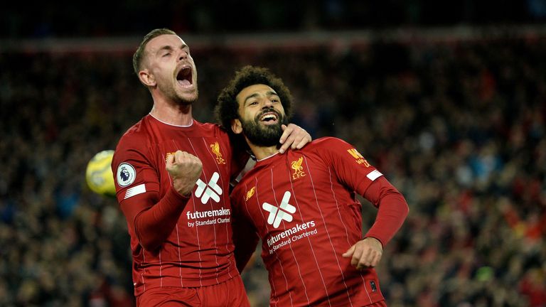 Jordan Henderson and Mohamed Salah celebrate Liverpool's win over Manchester City