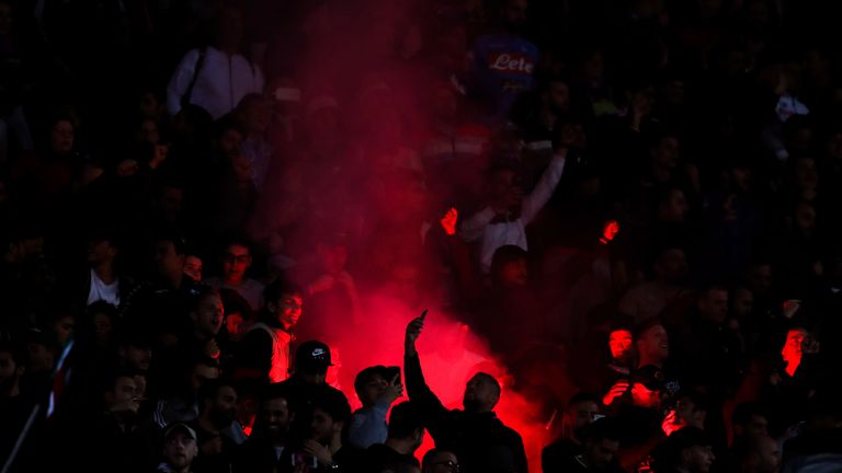 Fans of Napoli light a flare during the Champions League between Napoli and Liverpool in  2018