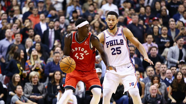 Pascal Siakam #43 of the Toronto Raptors dribbles the ball as Ben Simmons #25 of the Philadelphia 76ers defends during the second half of an NBA game at Scotiabank Arena on November 25, 2019 in Toronto, Canada.