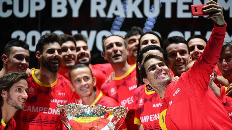 Rafael Nadal (R) takes a selfie photo posing with teammates and the winner's trophy during the trophy ceremony after winning the Davis Cup Madrid Finals 2019 in Madrid on November 24, 2019. 