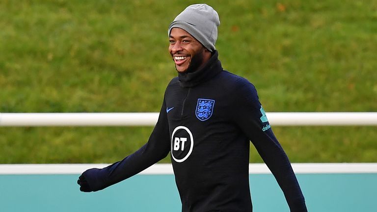 Raheem Sterling smiles during England training at St George's Park on Tuesday morning