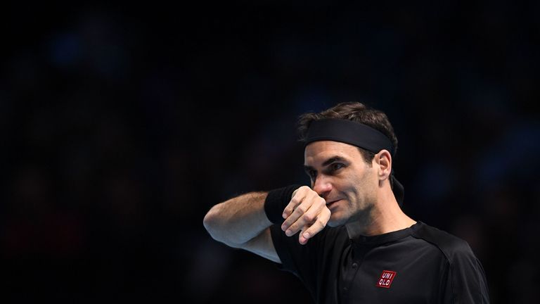 Roger Federer reacts as he returns against Greece's Stefanos Tsitsipas during the men's singles semi-final match on day seven of the ATP World Tour Finals tennis tournament at the O2 Arena in London on November 16, 2019