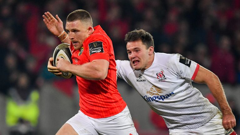 Andrew Conway beats the tackle of Jacob Stockdale of Ulster on the way to scoring his side's third try