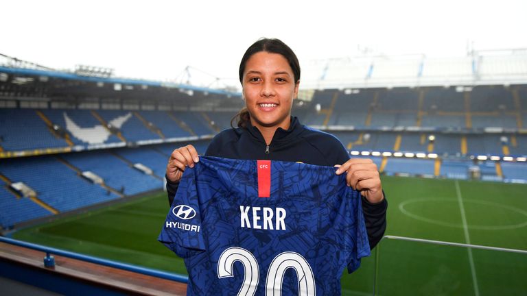 Sam Kerr poses for a photo at Stamford Bridge after signing for Chelsea