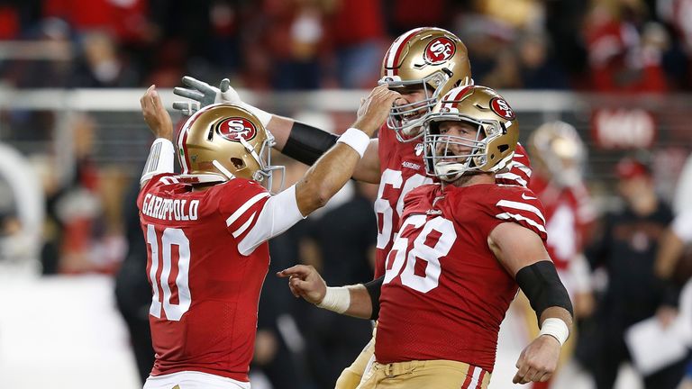 Quarterback Jimmy Garoppolo #10 of the San Francisco 49ers celebrates with Mike Person #68 and Mike McGlinchey #69 after throwing a touchdown pass to George Kittle #85 of the San Francisco 49ers #85 in the third quarter against the Green Bay Packers at Levi&#39;s Stadium on November 24, 2019 in Santa Clara, California.