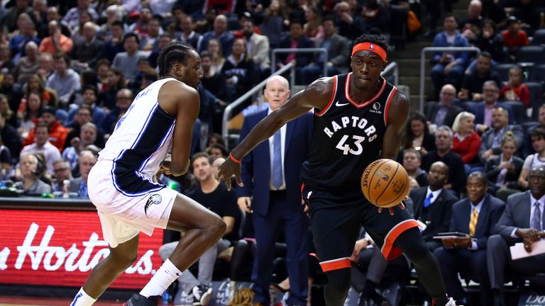 Pascal Siakam of the Toronto Raptors dribbles the ball as Al-Farouq Aminu of the Orlando Magic defends