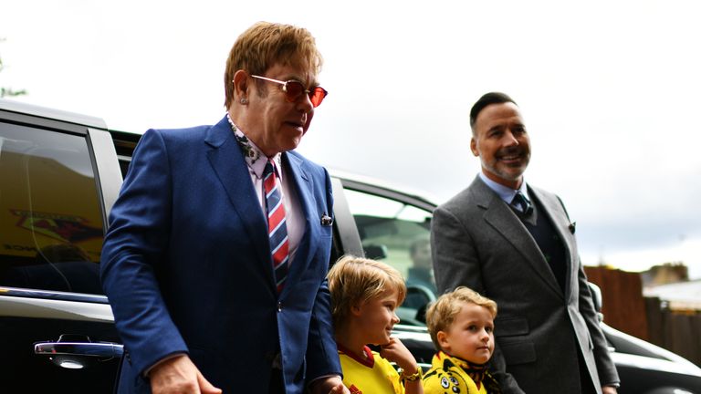 WATFORD, ENGLAND - SEPTEMBER 16: (L) Sir Elton John, Elijah Joseph Daniel Furnish-John, Zachary Jackson Levon Furnish-John and David Furnish (R) arrive at the stadium prior to the Premier League match between Watford and Manchester City at Vicarage Road on September 16, 2017 in Watford, England. (Photo by Dan Mullan/Getty Images)