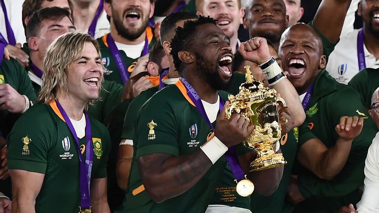 South Africa captain Siya Kolisi (C) lifts the Webb Ellis Cup as they celebrate winning the Japan 2019 Rugby World Cup final