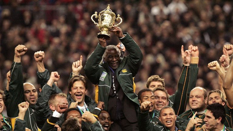 President Thabo Mbeki holds the trophy and celebrates with the South African team after their 2007 World Cup win