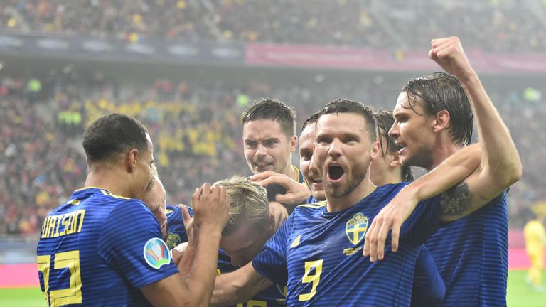 Marcus Berg is mobbed after putting Sweden into the lead in Bucharest
