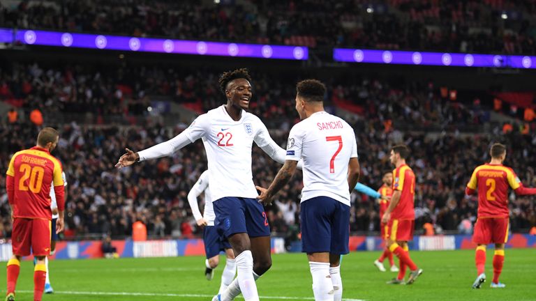 Tammy Abraham celebrates scoring England's seventh goal against Montenegro