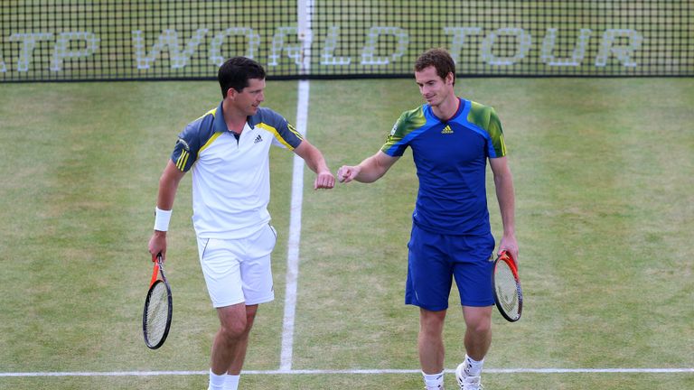 Tim Henman and Andy Murray punch fists during the Rally Against Cancer charity match on day seven of the AEGON Championships at Queens Club on June 16, 2013 in London, England. 