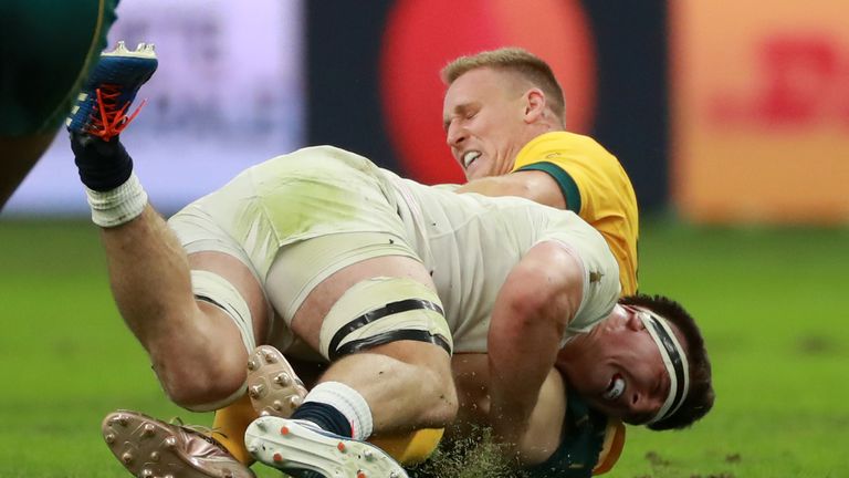 OITA, JAPAN - OCTOBER 19: Tom Curry of England tackles Reece Hodge during the Rugby World Cup 2019 Quarter Final match between England and Australia at Oita Stadium on October 19, 2019 in Oita, Japan. (Photo by David Rogers/Getty Images,)