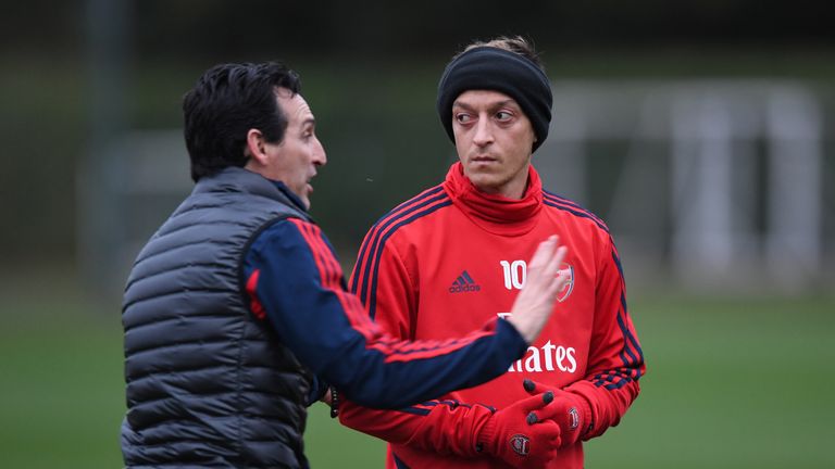 Unai Emery pictured with Mesut Ozil in training