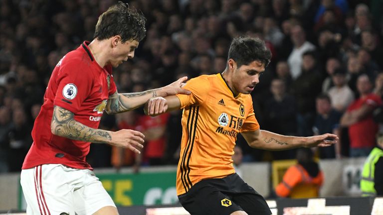Pedro Neto of Wolves holds off Victor Lindelof of Manchester United at Molineux