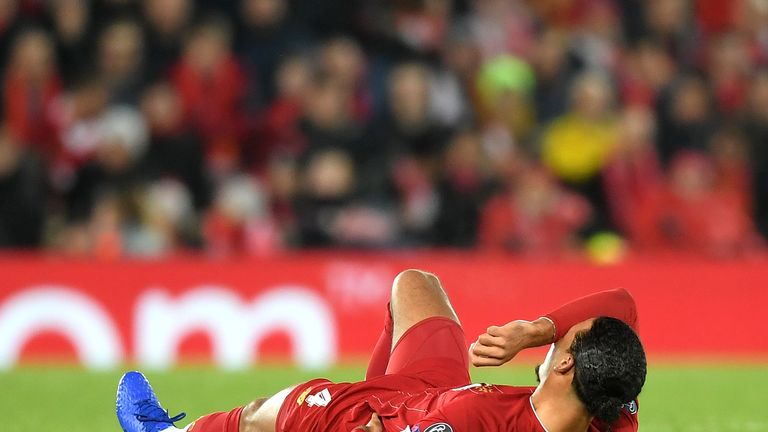 Virgil van Dijk of Liverpool reacts with an injury during the UEFA Champions League group E match between Liverpool FC and SSC Napoli at Anfield