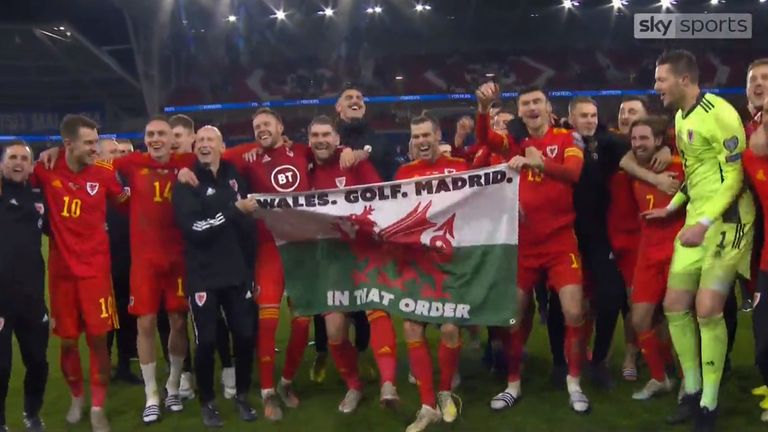 Gareth Bale celebrates Euro 2020 qualification with his team-mates by singing and parading a Wales flag which reads 'Wales. Golf. Madrid. In that order.'