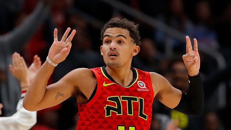 Trae Young celebrates after draining a three-pointer against San Antonio