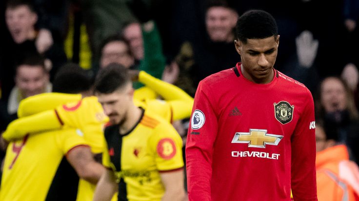 Marcus Rashford looks dejected as Watford celebrate during their win over Manchester United