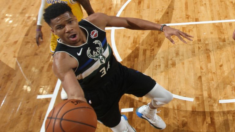 Giannis Antetokounmpo rises to the rim to score against the Los Angeles Lakers