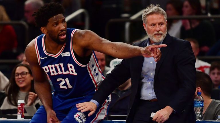 Joel Embiid questions a call from the scorer's table alongside Sixers coach Brett Brown
