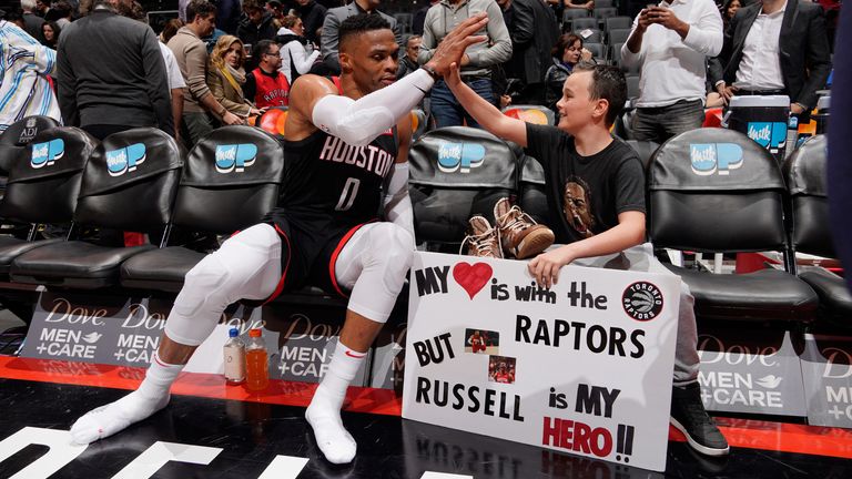 Russell Westbrook high-fives a fan in Toronto