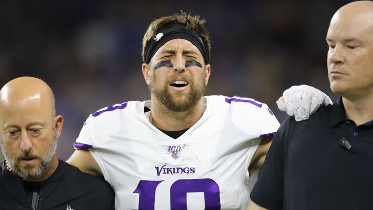 Adam Thielen is helped off the field after his first quarter touchdown catch against the Detroit Lions 