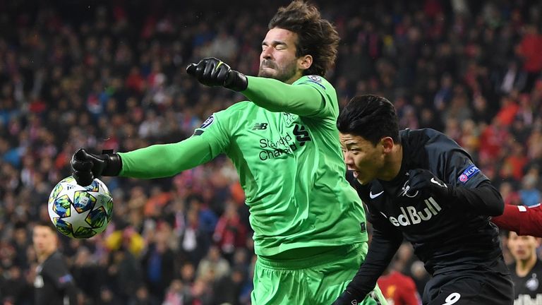 Alisson beats Red Bull Salzburg's Hwang to the ball