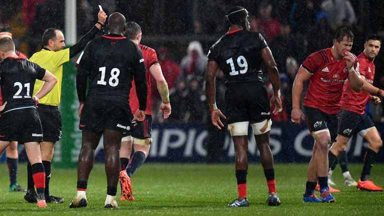 Arno Botha of Munster (2R) is shown a red card by Referee, Romain Poite for an elbow to Nick Tompkins of Saracens during the Heineken Champions Cup Round 3 match between Munster Rugby and Saracens at Thomond Park on December 07, 2019 in Limerick, Ireland.