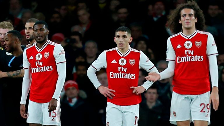 Arsenal players react after Manchester City's second goal 