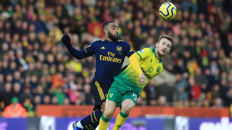Arsenal's Alexandre Lacazette (L) vies with Norwich's Tom Trybull