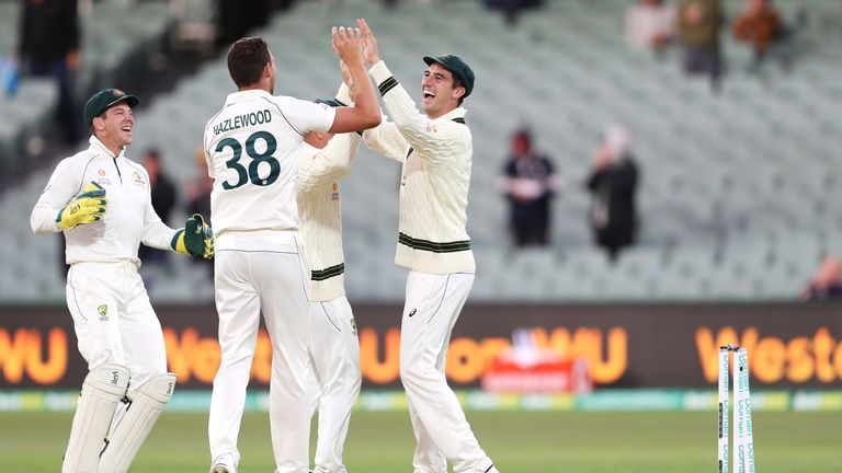 Josh Hazlewood (C) and Pat Cummins celebrate the run-out of Mohammad Abbas that clinched Australia's victory in the second Test