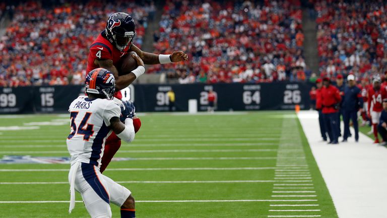 Deshaun Watson of the Houston Texans scores as he jumps over Will Parks of the Denver Broncos 