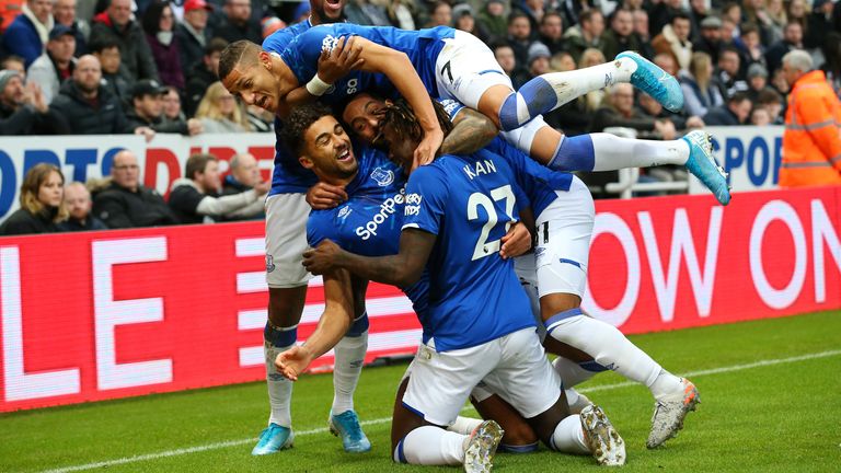 Calvert-Lewin is mobbed by his team-mates after his pinpoint opener