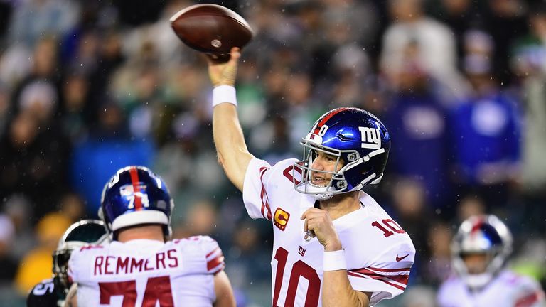 Quarterback Eli Manning of the New York Giants delivers a pass over the defense of the Philadelphia Eagles