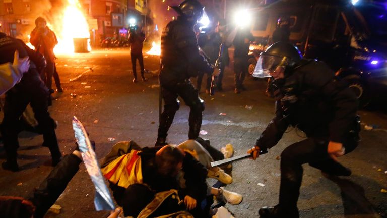 Riot police clash with protesters outside the Nou Camp during Barcelona v Real Madrid