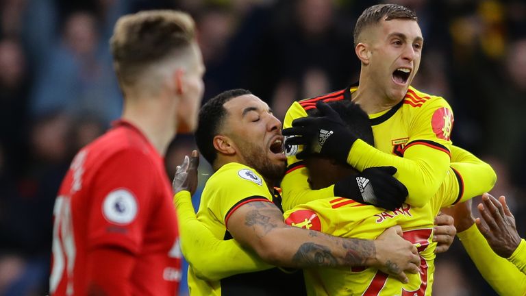 WATFORD, ENGLAND - DECEMBER 22: Ismaila Sarr of Watford (hidden) celebrates with teammates after scoring his team's first goal during the Premier League match between Watford FC and Manchester United at Vicarage Road on December 22, 2019 in Watford, United Kingdom.