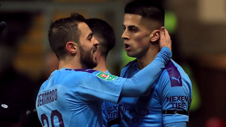 Manchester City's Joao Cancelo (right) celebrates scoring his side's first goal of the game with Bernardo Silva during the Carabao Cup quarter final match at Kassam Stadium, Oxford. PA Photo. Picture date: Wednesday December 18, 2019. See PA story SOCCER Oxford. Photo credit should read: Mike Egerton/PA Wire. RESTRICTIONS: EDITORIAL USE ONLY No use with unauthorised audio, video, data, fixture lists, club/league logos or "live" services. Online in-match use limited to 120 images, no video emulation. No use in betting, games or single club/league/player publications.
