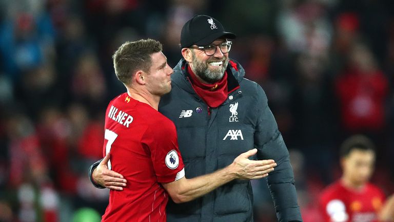 Jurgen Klopp and Milner embrace after the Merseyside derby win