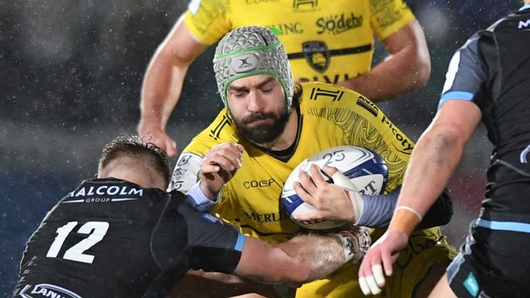 La Rochelle's French flanker Kevin Gourdon (C) is tackled by Glasgow Warriors' Scottish centre Stafford McDowall (L) during the European Rugby Champions Cup Group B match between Glasgow Warriors and La Rochelle at Scotstoun Stadium in Glasgow, Scotland on December 14, 2019. (Photo by ANDY BUCHANAN / AFP) (Photo by ANDY BUCHANAN/AFP via Getty Images)
