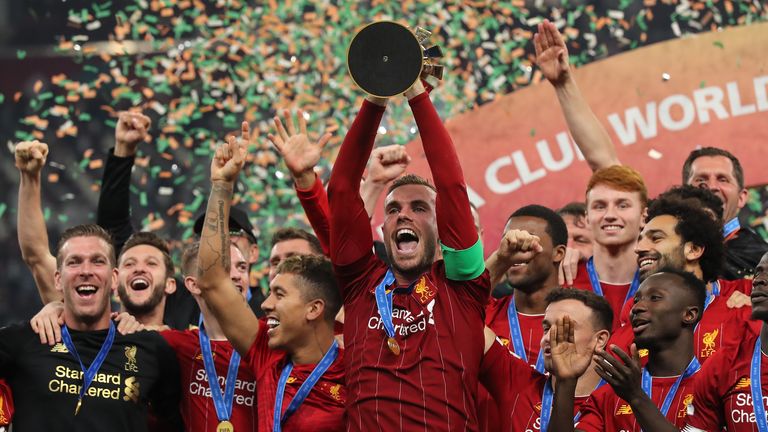 Liverpool captain Jordan Henderson lifts the Club World Cup trophy